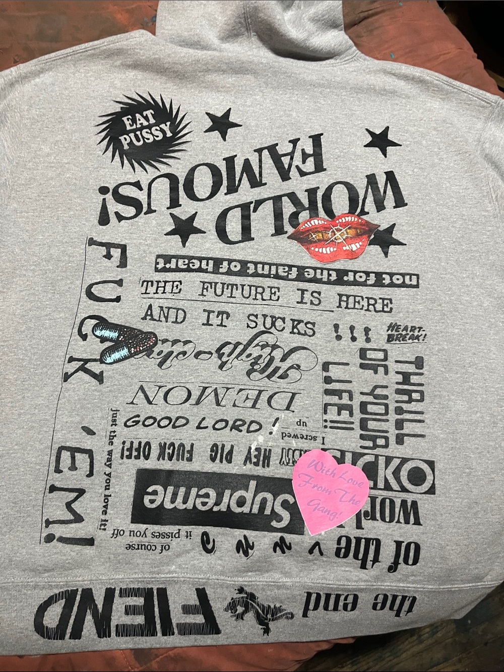 Supreme Gray Hoodie with Black Graphic and Pink Accent